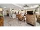 Open-concept living room and kitchen, featuring wood-look tile flooring, recessed lighting, and modern appliances at 8344 Sw 79Th Cir, Ocala, FL 34476