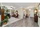 Open living area with wood-look floors, stylish furniture, and access to other rooms at 8344 Sw 79Th Cir, Ocala, FL 34476