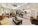 Spacious open-concept living room with a ceiling fan, breakfast bar, and seamless flow to the modern kitchen at 8344 Sw 79Th Cir, Ocala, FL 34476