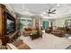 Spacious living room featuring tray ceilings, neutral decor, and a seamless transition to the outdoors at 8344 Sw 79Th Cir, Ocala, FL 34476