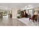 Open-concept living room features tile flooring, crown molding, and abundant natural light at 8344 Sw 79Th Cir, Ocala, FL 34476