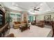 Large living room with tile flooring, tray ceiling, and comfortable furnishings at 8344 Sw 79Th Cir, Ocala, FL 34476