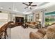 Cozy living room with plush seating, tray ceiling, and a ceiling fan at 8344 Sw 79Th Cir, Ocala, FL 34476