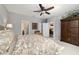 Cozy main bedroom features a ceiling fan, large bed, and a seating area for relaxing at 8344 Sw 79Th Cir, Ocala, FL 34476