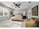 Serene main bedroom features a ceiling fan, large window, and comfortable seating area at 8344 Sw 79Th Cir, Ocala, FL 34476
