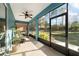 Relaxing screened-in patio with ceiling fan and backyard view perfect for enjoying the outdoors comfortably at 8344 Sw 79Th Cir, Ocala, FL 34476