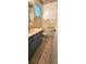 The bathroom has a blue vanity with a sink, and a window with blinds to let sunlight in at 8449 Sw 106Th Pl, Ocala, FL 34481