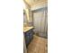 Bathroom with blue vanity, tile flooring, toilet, and shower with curtain at 8449 Sw 106Th Pl, Ocala, FL 34481