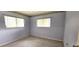 Simple carpeted bedroom with two large windows bringing in lots of natural light at 8449 Sw 106Th Pl, Ocala, FL 34481