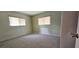 Bright bedroom features two windows and a neutral carpeted floor at 8449 Sw 106Th Pl, Ocala, FL 34481