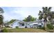 Charming single-story home featuring a well-maintained lawn and mature landscaping with a palm tree at 8449 Sw 106Th Pl, Ocala, FL 34481