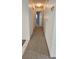 Neutral hallway featuring patterned carpet that leads to other rooms in the home at 8449 Sw 106Th Pl, Ocala, FL 34481