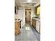 Bright kitchen area featuring tile floors, wooden cabinets, and white appliances at 8449 Sw 106Th Pl, Ocala, FL 34481