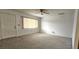 Living room with overhead fan, carpet, and adjacent front door at 8449 Sw 106Th Pl, Ocala, FL 34481
