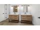 Modern bathroom featuring double sinks, wood cabinets, matte black fixtures, and stylish lighting at 8850 Sw 125Th Ter, Dunnellon, FL 34432