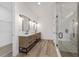 Modern bathroom featuring dual vanities and a glass-enclosed shower at 8850 Sw 125Th Ter, Dunnellon, FL 34432