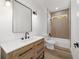 Bathroom with modern vanity, black hardware and lighting, with a tiled shower/tub combo at 8850 Sw 125Th Ter, Dunnellon, FL 34432