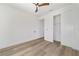 Light filled bedroom with wood-look floors, closet, and bright white walls at 8850 Sw 125Th Ter, Dunnellon, FL 34432
