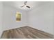 Bright bedroom featuring wood-look flooring, a ceiling fan, and a window with a scenic outdoor view at 8850 Sw 125Th Ter, Dunnellon, FL 34432