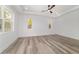 Bright primary bedroom with tray ceiling and large windows at 8850 Sw 125Th Ter, Dunnellon, FL 34432