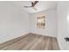 Spacious bedroom with light wood-look floors, bright white walls, ceiling fan, and window at 8850 Sw 125Th Ter, Dunnellon, FL 34432