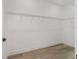 Walk-in closet featuring wood-look floors, white walls, and wire shelving at 8850 Sw 125Th Ter, Dunnellon, FL 34432