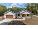 Attractive single-Gathering home featuring a modern design, attached garage, and landscaped front yard at 8850 Sw 125Th Ter, Dunnellon, FL 34432
