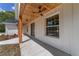 Inviting front porch with wood ceiling, a ceiling fan, and decorative plants, enhancing curb appeal at 8850 Sw 125Th Ter, Dunnellon, FL 34432