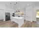 Contemporary kitchen with white cabinetry, stainless steel fridge, center island, and recessed lighting at 8850 Sw 125Th Ter, Dunnellon, FL 34432