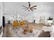 Open-concept living room featuring modern furniture, a ceiling fan, and seamless flow to the kitchen at 8850 Sw 125Th Ter, Dunnellon, FL 34432