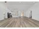 Open concept view of living area featuring hard wood flooring and ample space, connecting the kitchen and living spaces at 8850 Sw 125Th Ter, Dunnellon, FL 34432