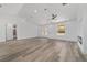 Modern living space featuring wood-look floors, a ceiling fan, and a view of a cozy fireplace at 8850 Sw 125Th Ter, Dunnellon, FL 34432