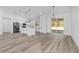 Open-concept living area featuring white kitchen, oversized island, and sliding glass doors leading to backyard at 8850 Sw 125Th Ter, Dunnellon, FL 34432