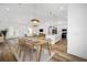 Open living and dining area boasting stylish decor, modern lighting, and seamless access to the kitchen at 8850 Sw 125Th Ter, Dunnellon, FL 34432