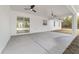 Large covered patio with dual ceiling fans and sliding glass doors, blending indoor and outdoor living at 8850 Sw 125Th Ter, Dunnellon, FL 34432
