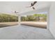 Covered patio with ceiling fans overlooks expansive backyard, providing a relaxing outdoor living space at 8850 Sw 125Th Ter, Dunnellon, FL 34432