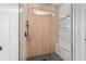 Close-up of a glass enclosed shower with wood-look tile, bench, and a rain shower head at 8850 Sw 125Th Ter, Dunnellon, FL 34432