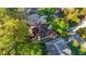 Aerial view of a charming home with a chimney, beautiful landscaping, and a well-maintained lawn at 8869 Sw 194Th Ct, Dunnellon, FL 34432