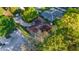 Stunning aerial shot of a home with mature landscaping, a circular driveway, and a backyard screen enclosure at 8869 Sw 194Th Ct, Dunnellon, FL 34432