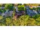 Aerial view of a home with a well-manicured lawn, lush trees, and a driveway, in a quiet neighborhood at 8869 Sw 194Th Ct, Dunnellon, FL 34432