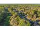 Picturesque aerial view of homes along a green golf course, surrounded by a lush forest at 8869 Sw 194Th Ct, Dunnellon, FL 34432