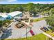 Aerial view of community center building with parking, landscaping, and accessible walkways at 8869 Sw 194Th Ct, Dunnellon, FL 34432