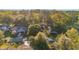 An aerial view shows the property nestled among lush trees, featuring well-maintained landscaping at 8869 Sw 194Th Ct, Dunnellon, FL 34432