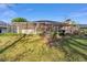Backyard view of the screened-in patio and lush landscaping at 8869 Sw 194Th Ct, Dunnellon, FL 34432
