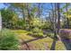 Lush backyard featuring mature trees and landscaping creating a private and serene outdoor space for relaxation and recreation at 8869 Sw 194Th Ct, Dunnellon, FL 34432