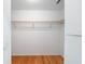 Walk-in closet with hardwood floors featuring a single shelf and hanging rod at 8869 Sw 194Th Ct, Dunnellon, FL 34432