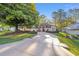 Beautiful home exterior with a spacious driveway, lush landscaping, and a well-maintained lawn at 8869 Sw 194Th Ct, Dunnellon, FL 34432