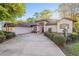 Inviting single-story home featuring a three-car garage and meticulously manicured landscaping at 8869 Sw 194Th Ct, Dunnellon, FL 34432