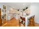 Bright kitchen with hardwood floors, white cabinets, a breakfast bar, and an eat-in nook at 8869 Sw 194Th Ct, Dunnellon, FL 34432