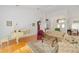 Bright and airy living room featuring high ceilings, hardwood floors, and elegant furnishings creating a comfortable space at 8869 Sw 194Th Ct, Dunnellon, FL 34432
